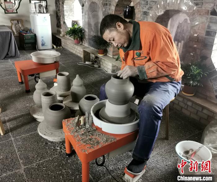 梁小板在陶瓷體驗館內(nèi)忙碌著?！罱苡?攝